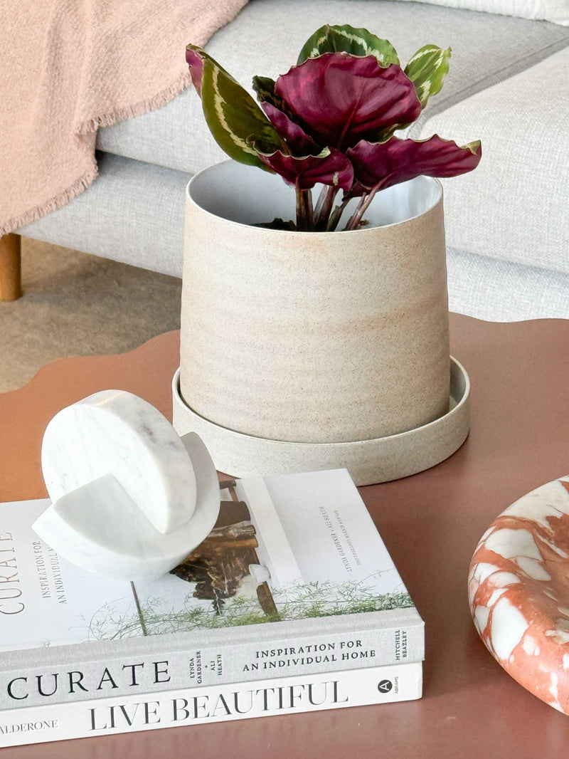 Robert Gordon Garden stoneware planter with tray featuring earthy clay body and organic glaze on a coffee table.