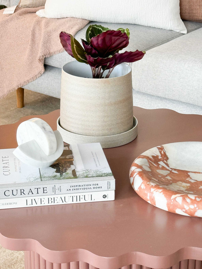 Robert Gordon Garden To Table stoneware planter with tray on pink scalloped table with books and decorative objects