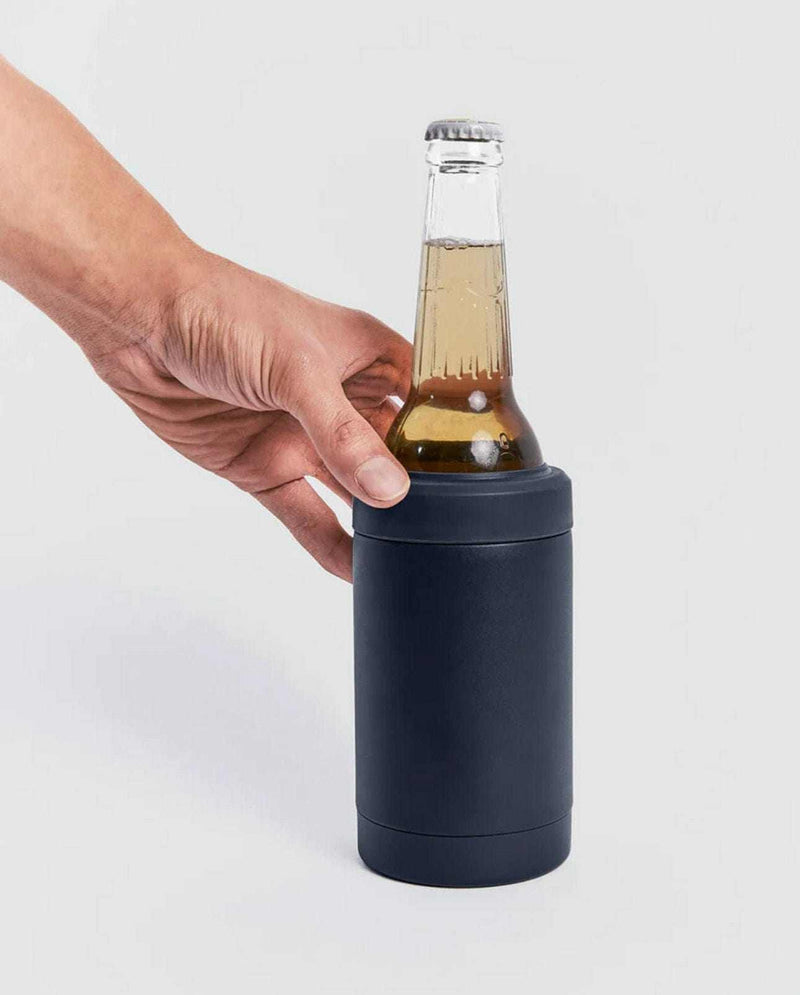 Navy Beysis Drinks Cooler made of stainless steel holding a cold bottle with a hand reaching to grab it