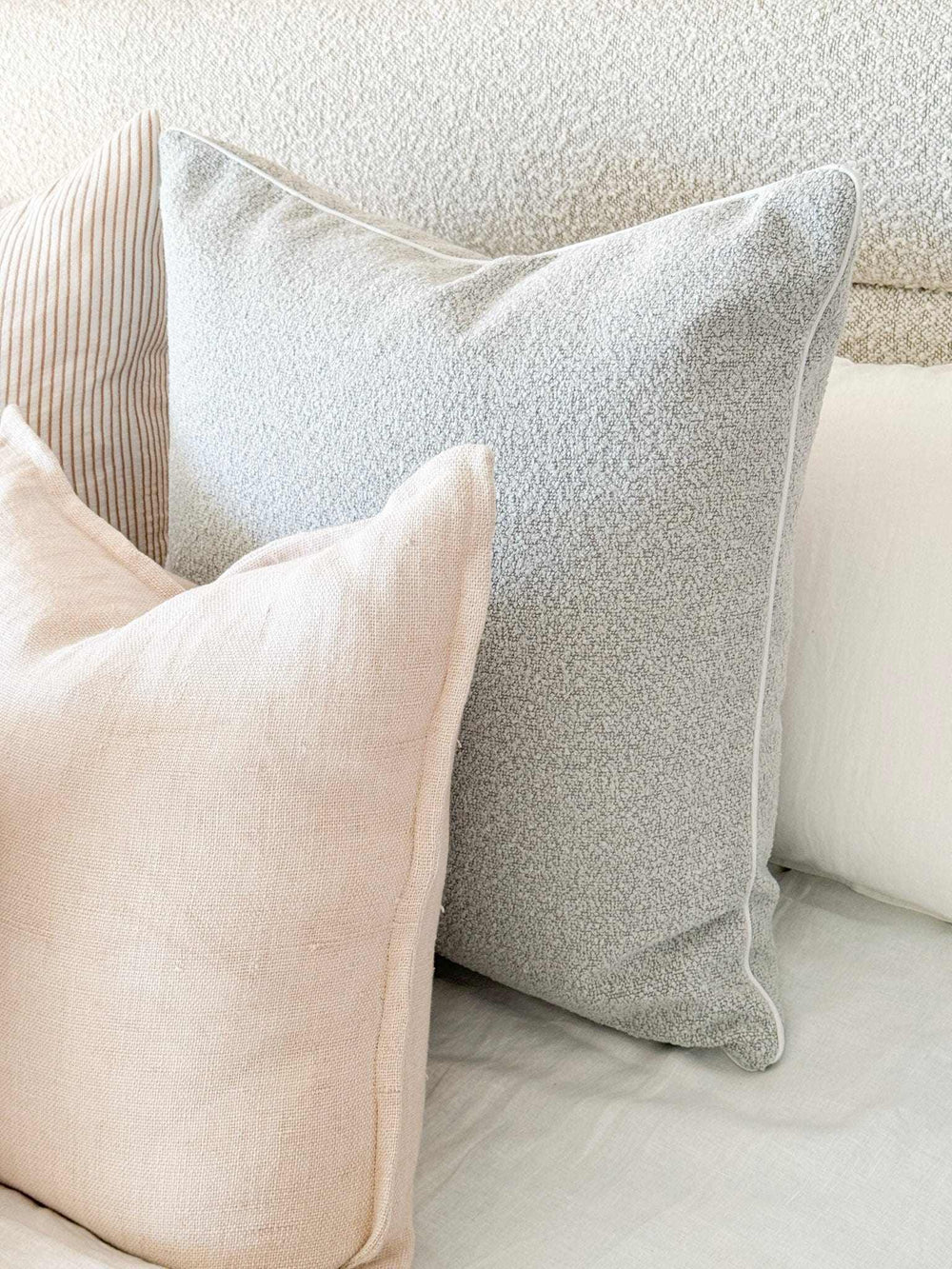 norsu Studio Cushion in powder blue boucle with white leather piping, handcrafted luxury, various sizes