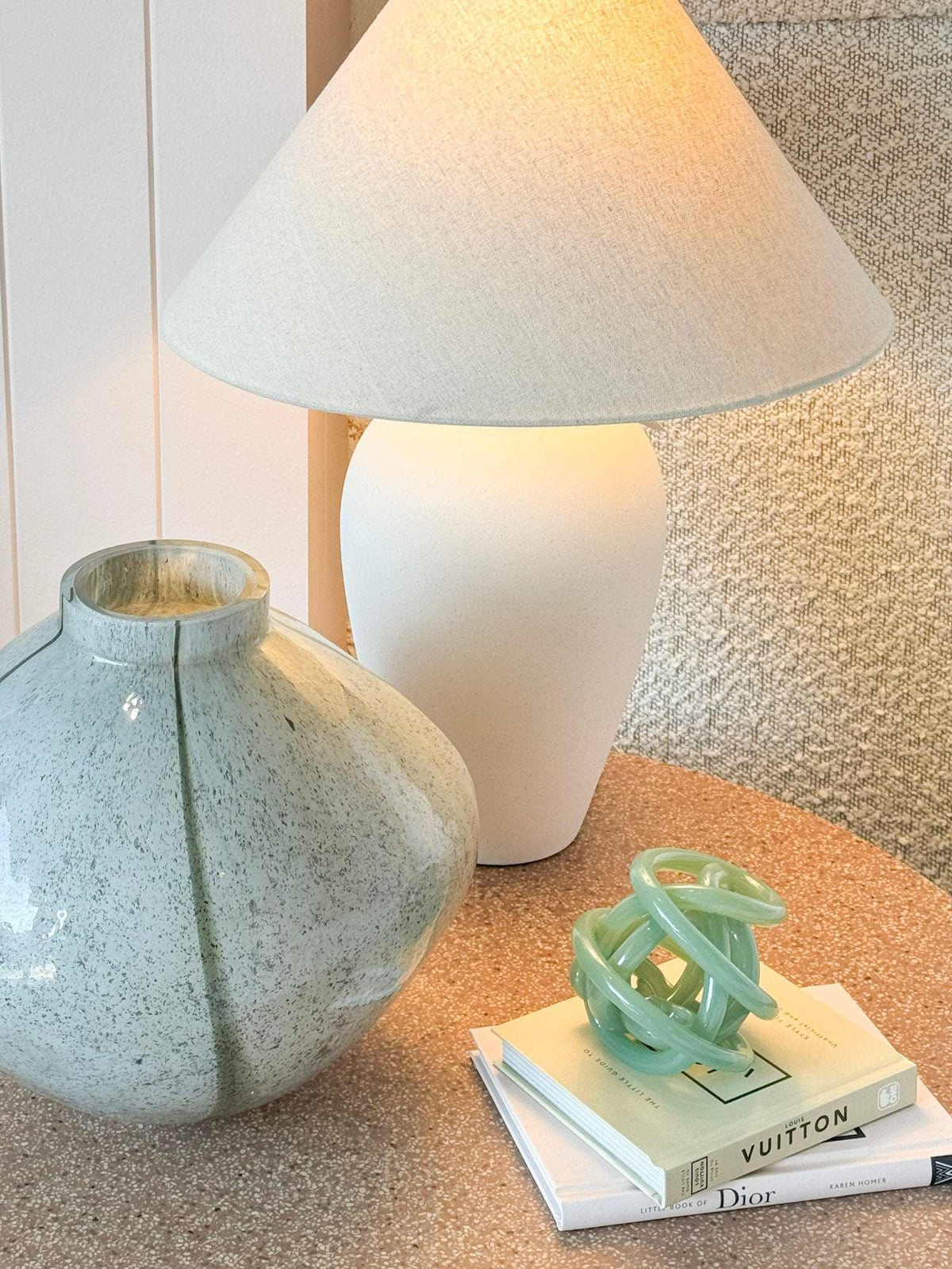 GlobeWest Boden Stripe vase wide sage handblown glass with delicate stripes on table next to lamp and books