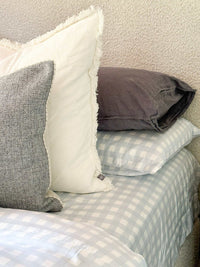 Mulberry Threads Sky Gingham bamboo sheet set in light blue gingham pattern with soft pillows on a cozy bed