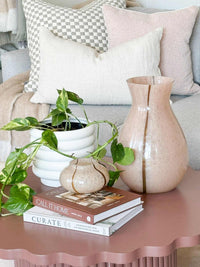 GlobeWestBoden Stripe tall blush glass vase with stripe pattern on pink table next to plant and decorative items
