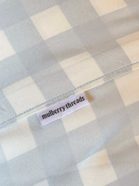 Mulberry Threads Sky Gingham bamboo sheet set with soft blue gingham organic fabric label close-up