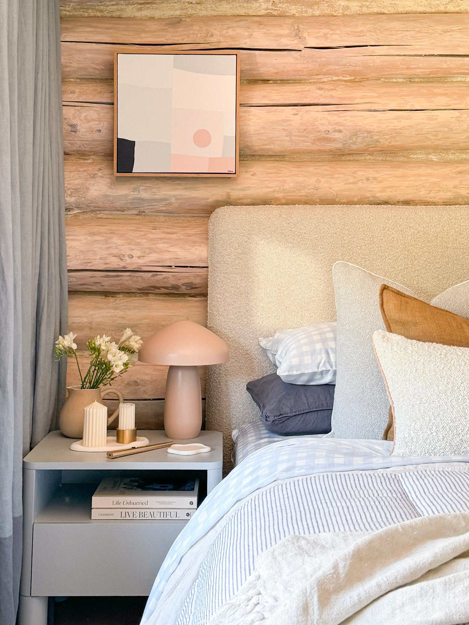 Cozy bedroom featuring Mulberry Threads Sky Gingham bamboo sheet set on bed with soft pillows and rustic wooden wall background