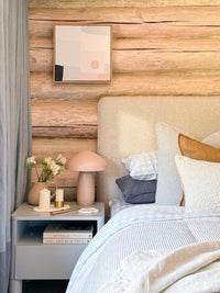 Cozy bedroom featuring Mulberry Threads Sky Gingham bamboo sheet set on bed with soft pillows and rustic wooden wall background