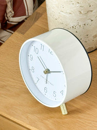 Maisie Silent Tick Alarm Clock white vintage style with gold accents and nightlight function on wooden surface