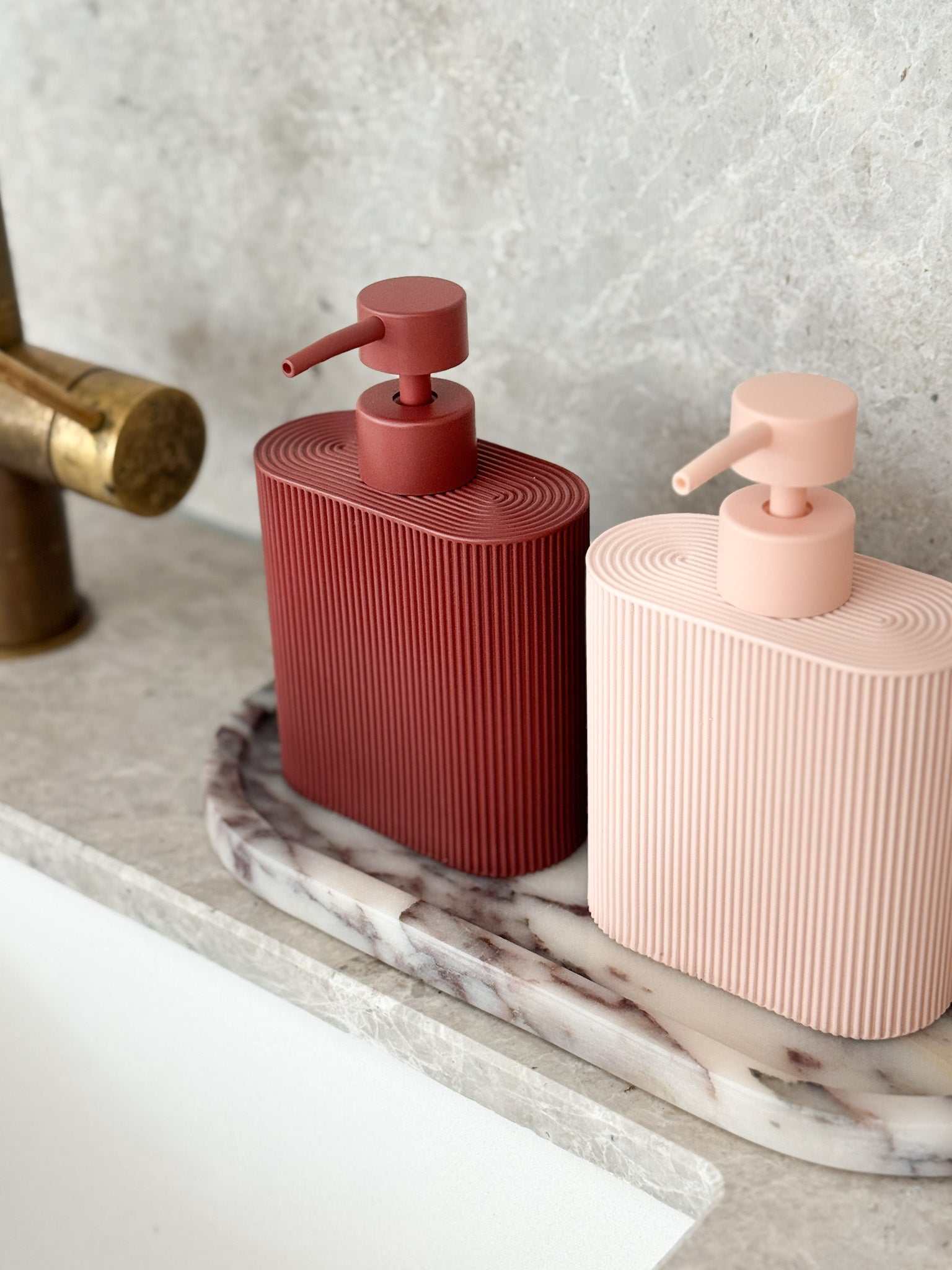 Rose-colored Rosie resin dispenser with ridged grip for bathroom and kitchen refill use