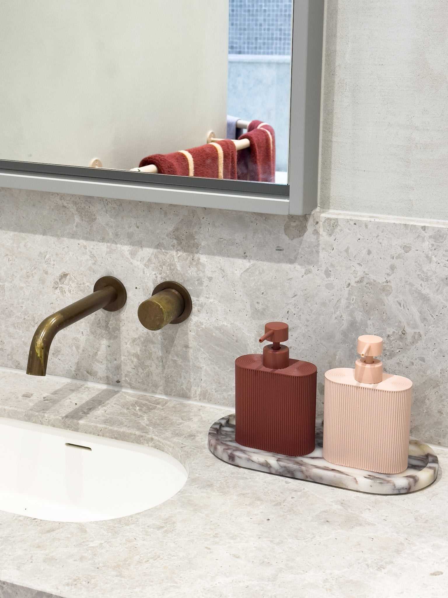 Rose-colored Rosie resin dispenser with ridged grip for kitchen or bathroom use