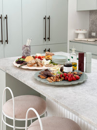norsu Studio Spin Me Round blush acrylic lazy susan with scalloped edge and rotating base in two sizes