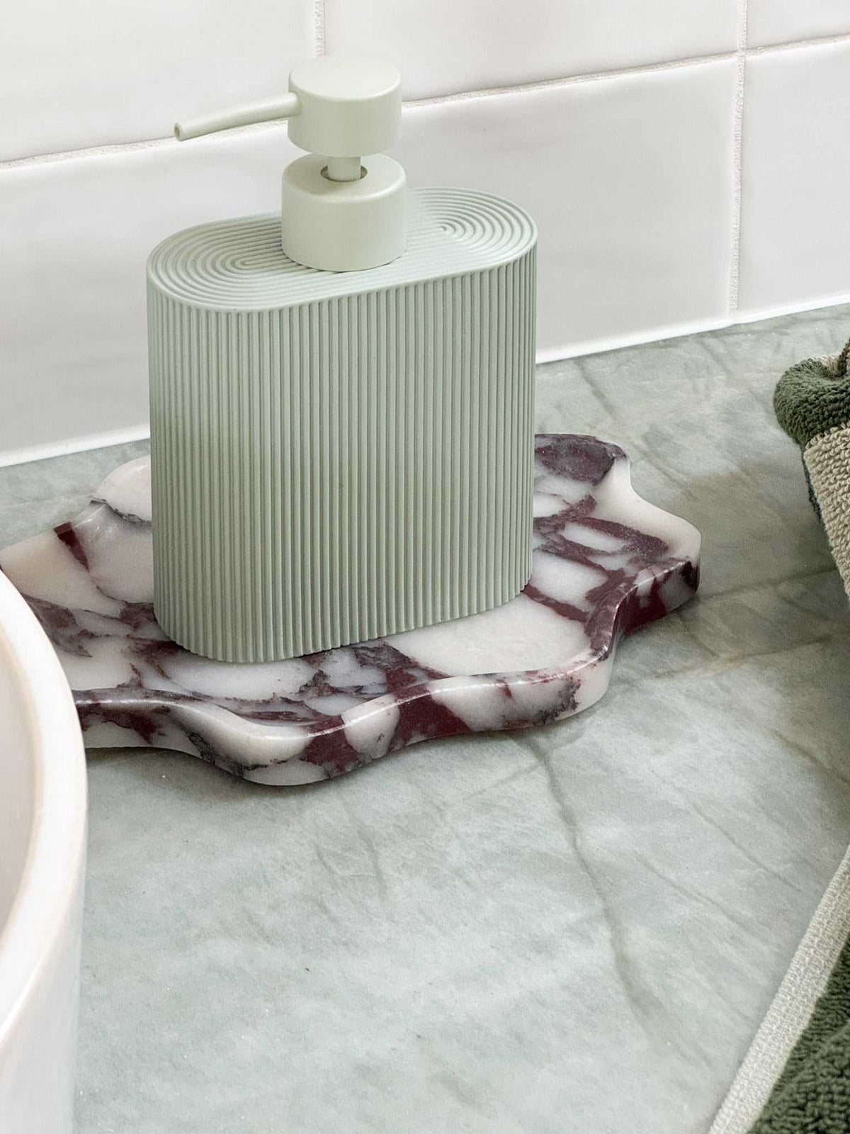 Rosie Sid Resin Dispenser in seafoam color with ridged grip for kitchen or bathroom use