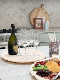 norsu Studio Spin Me Round blush acrylic lazy susan with scalloped edge and smooth rotating base, available in two sizes