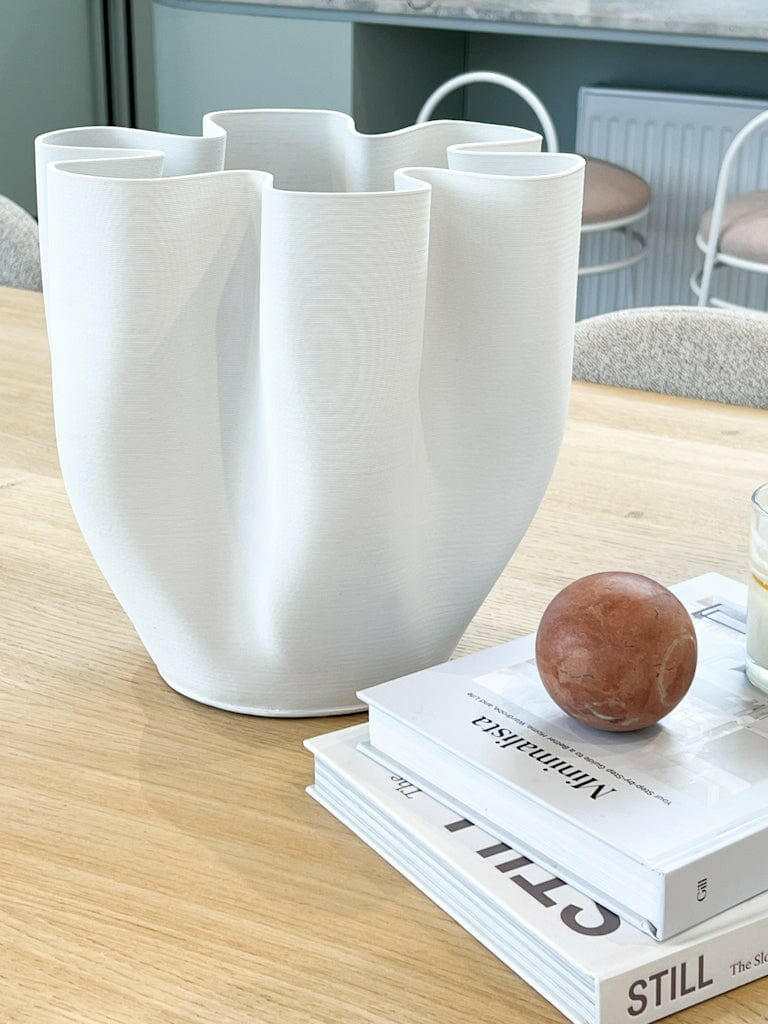 White matte ceramic Bailey Decorative Vase with curved design on wooden table