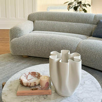 CoTheory small brown Calacatta marble sculptural tray on a marble coffee table in a modern living room setting