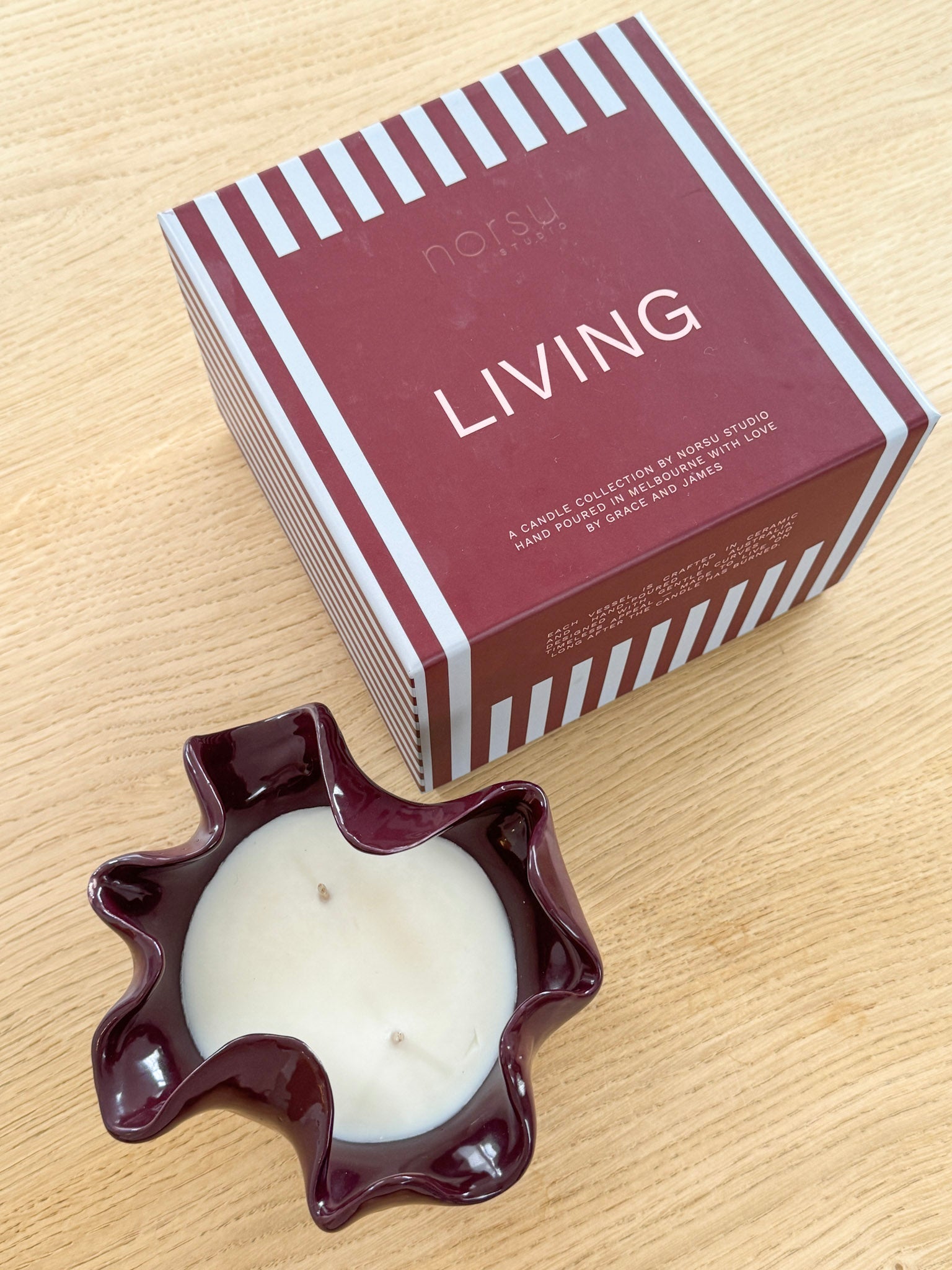 norsu Studio Flow burgundy sculptural ceramic scented candle with Antibes fragrance and ruffled edge vessel