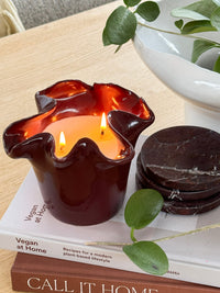 norsu Studio Flow sculptural ceramic scented candle in burgundy with Antibes fragrance and ruffled-edge design