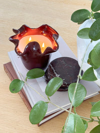 norsu Studio Flow sculptural ceramic scented candle in burgundy with Antibes fragrance and ruffled edge design