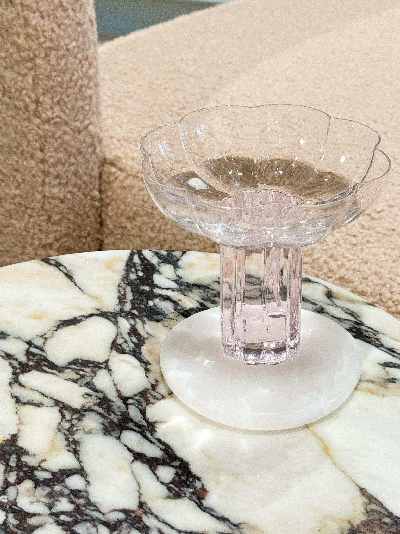 Black Blaze White Onyx marble coaster with unique natural patterns on table surface