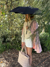 BLUNT Metro Umbrella in ink black, compact and stylish, featuring durable windproof design and 360° spinning technology, shown open outdoors.