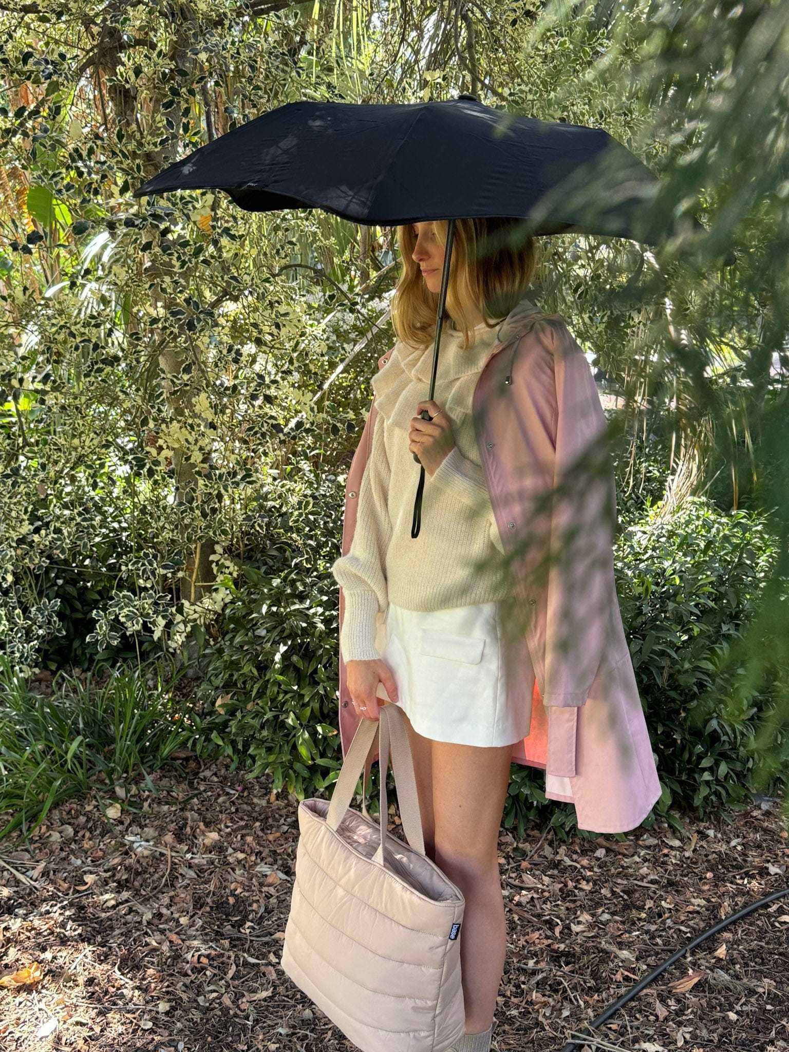 BLUNT Metro Umbrella in ink black, compact and stylish, featuring durable windproof design and 360° spinning technology, shown open outdoors.