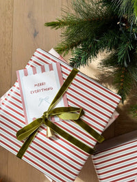norsu Studio Christmas Wrapping Paper jumbo roll with red and white stripe design gift wrap under Christmas tree