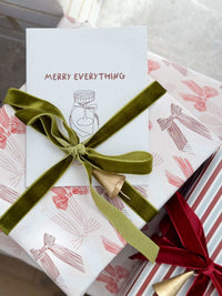 Norsu Studio Christmas Wrapping Paper jumbo roll with pink bow design, green velvet ribbon, and festive gift wrap.