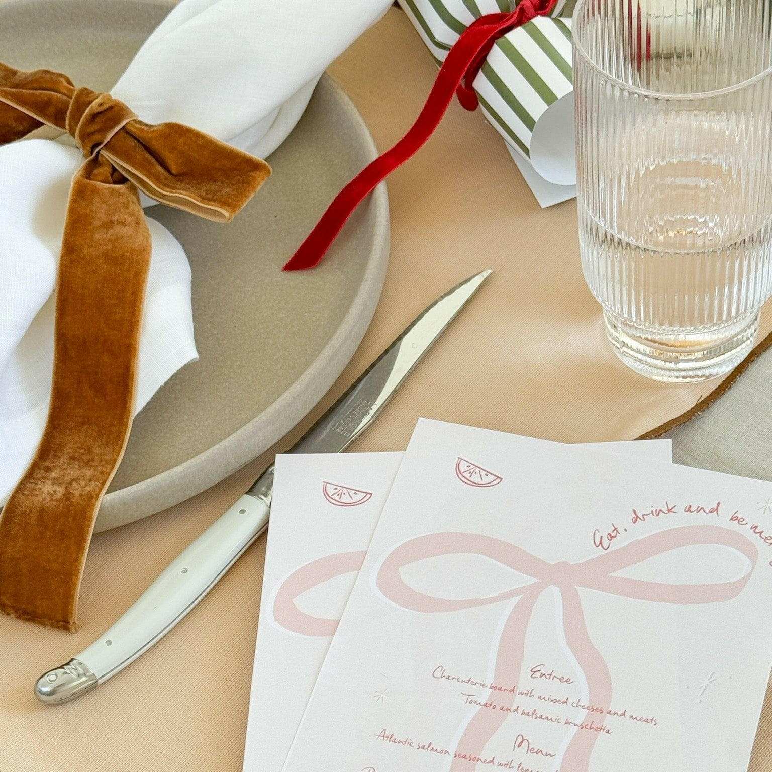 Same Time Tomorrow Napkin Ring set of 6 caramel velvet bow napkin holders on beige table setting with white plate and glass