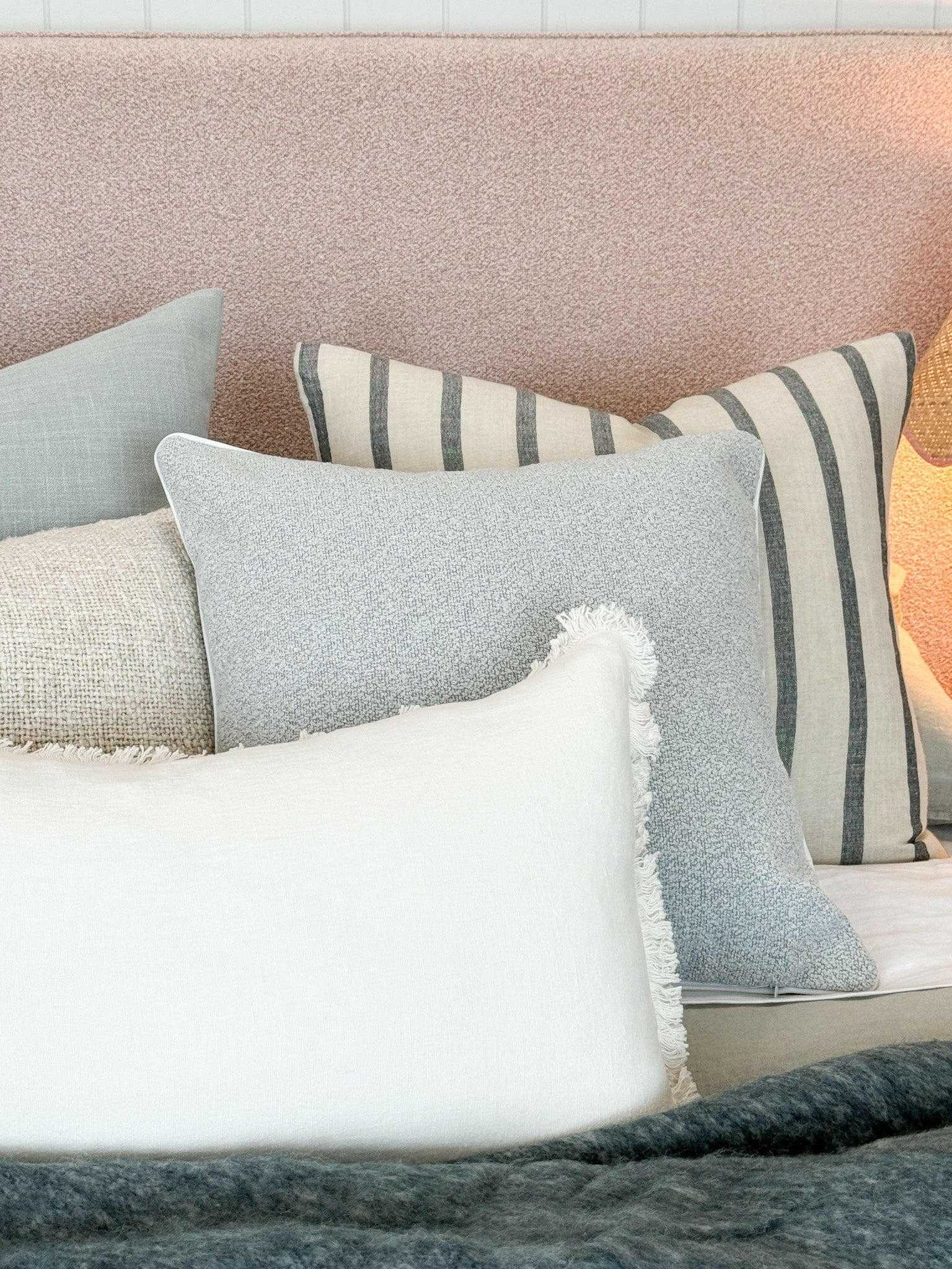 Eadie Lifestyle Luca white boho cushion with hand-frayed edging in various sizes on a sofa setting