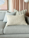 Baya Cyprian Oblong Cushion in oatmeal, textured soft yarn lumbar pillow on grey sofa