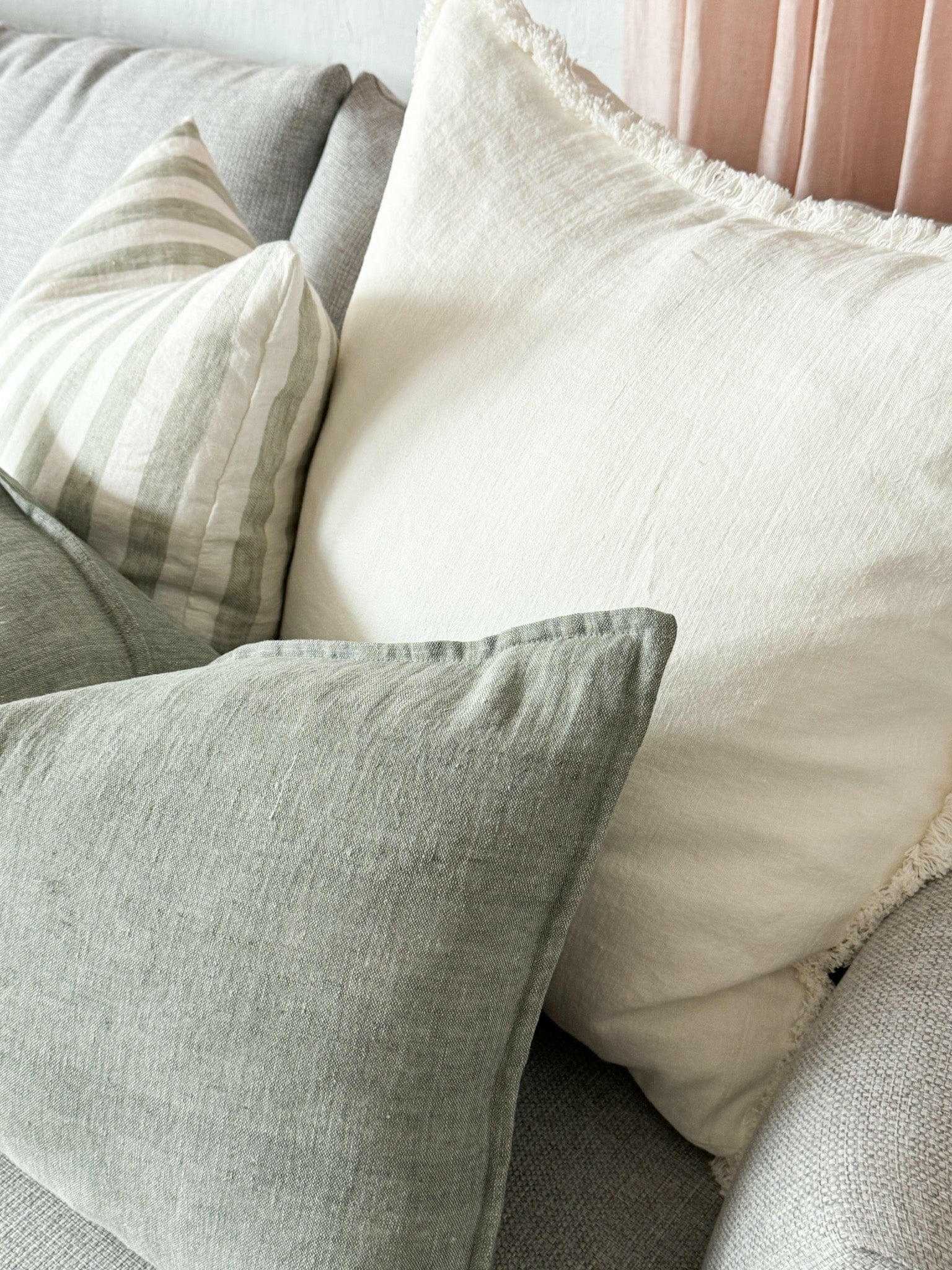 White hand-frayed linen boho cushion on sofa, Eadie Lifestyle Luca design
