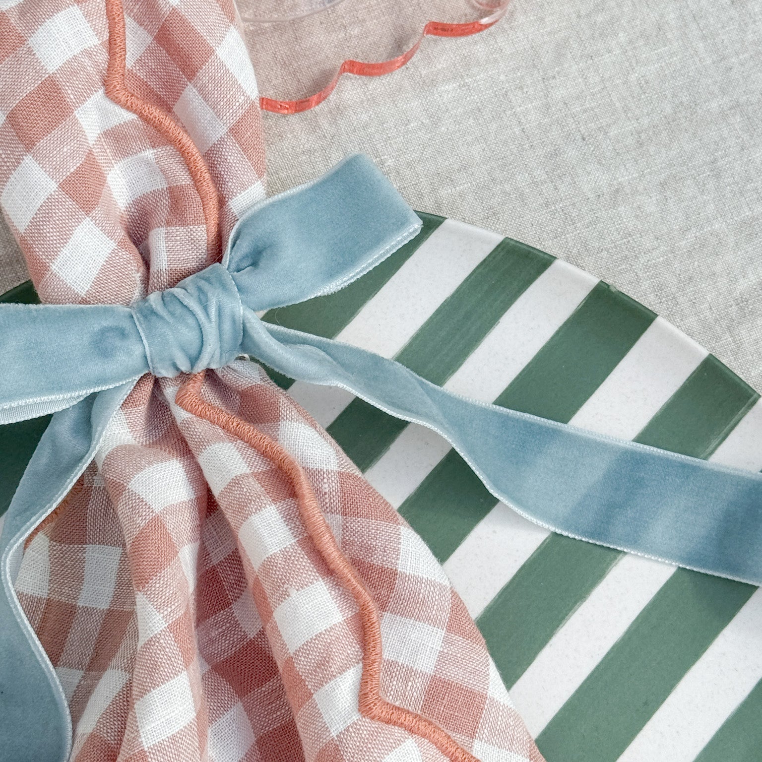 Same Time Tomorrow velvet bow napkin ring in duck egg blue on checked napkin and striped plate table setting