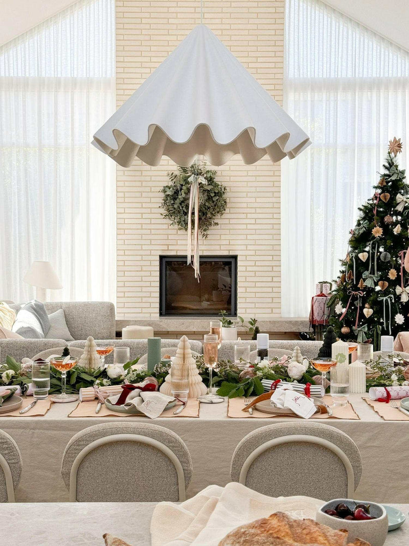 L&M Terrace Oatmeal Tablecloth on festive dining table with elegant Christmas decor in bright living room