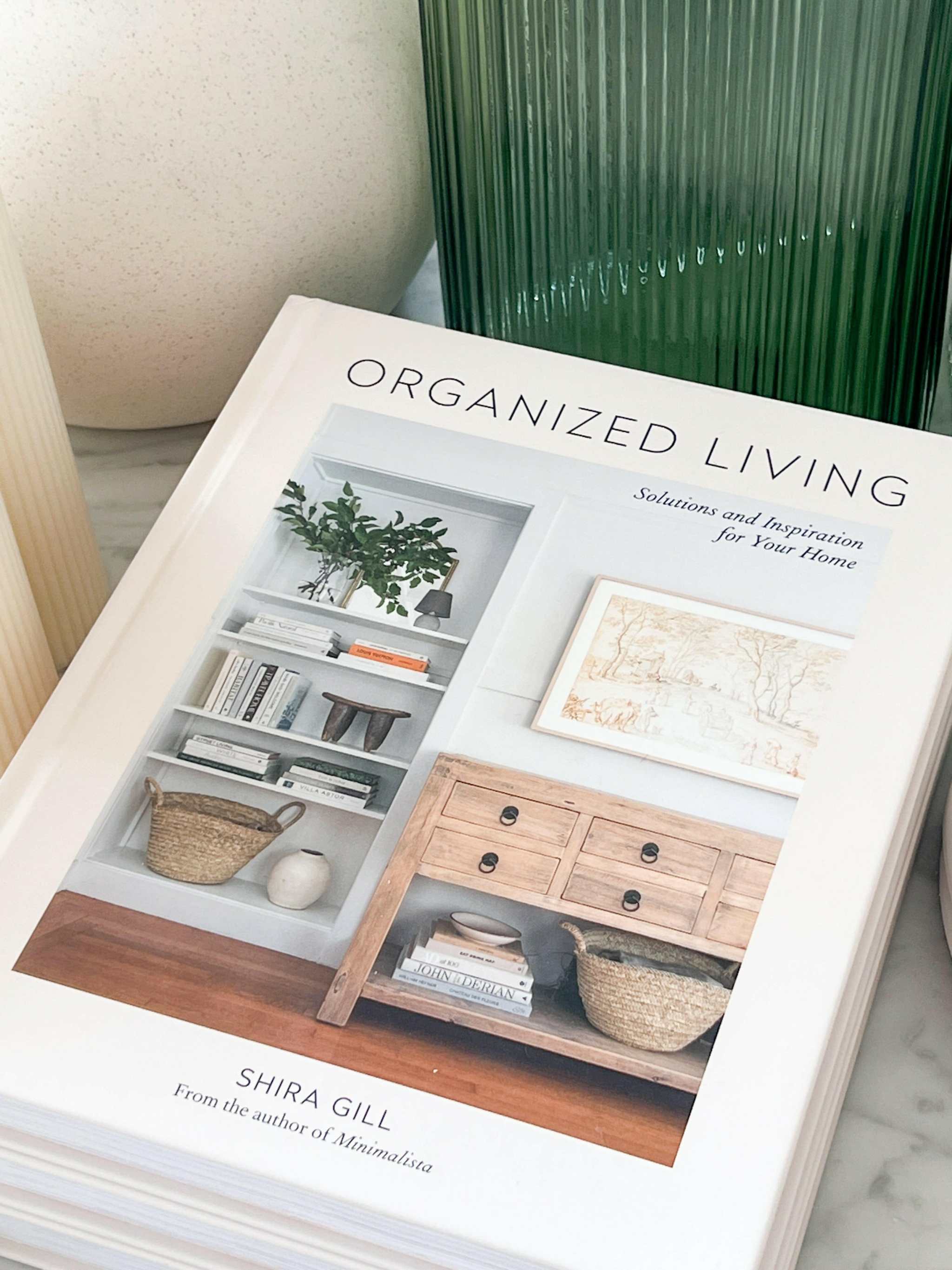 Organized Living book by Shira Gill on home organization with styled shelves and wooden cabinet on cover
