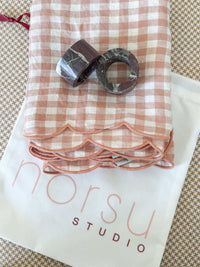 norsu Studio Linen blush gingham scallop-edged napkins set with marble napkin rings and storage bag