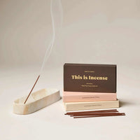 Gentle Habits Incense sticks with smoker in marble holder and packaging boxes showcasing grounding essential oil blend