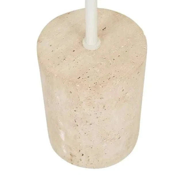 Close-up of the natural travertine base of the Easton Marquee Floor Lamp in matt ivory finish