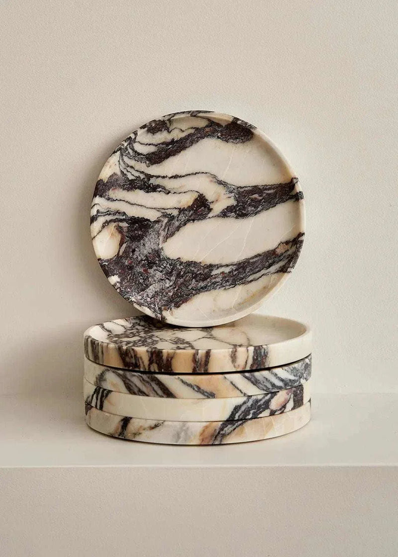 Stack of Linea Round Marble Trays made from Calacatta Viola stone with natural black and cream veining.