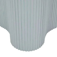 Close-up of powder blue Artie Wave Ripple Side Table base with ripple pillar design