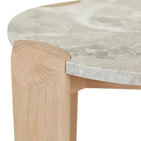 Close-up of GlobeWest Willa Marble side table featuring grey marble round top and light oak legs