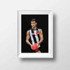 Framed Dom Gauci kids art print of Nick Daicos in Collingwood AFL football uniform holding a football on grey background