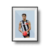 Framed Dom Gauci Kids Art Print of Nick Daicos in Collingwood AFL football uniform holding a red football on powder blue background