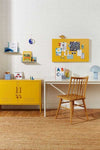 Yellow Mustard Made magnetic storyboard mounted on wall above desk with matching mustard lockers in stylish workspace