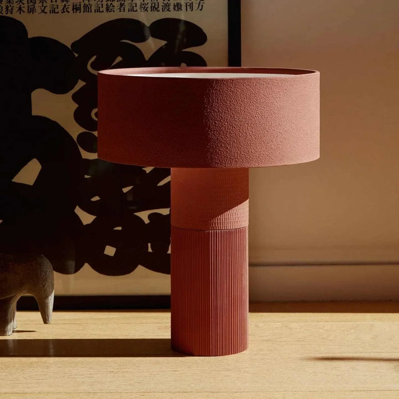 POTT Lighting Terra table lamp in rust color with textured clay finish and modern design