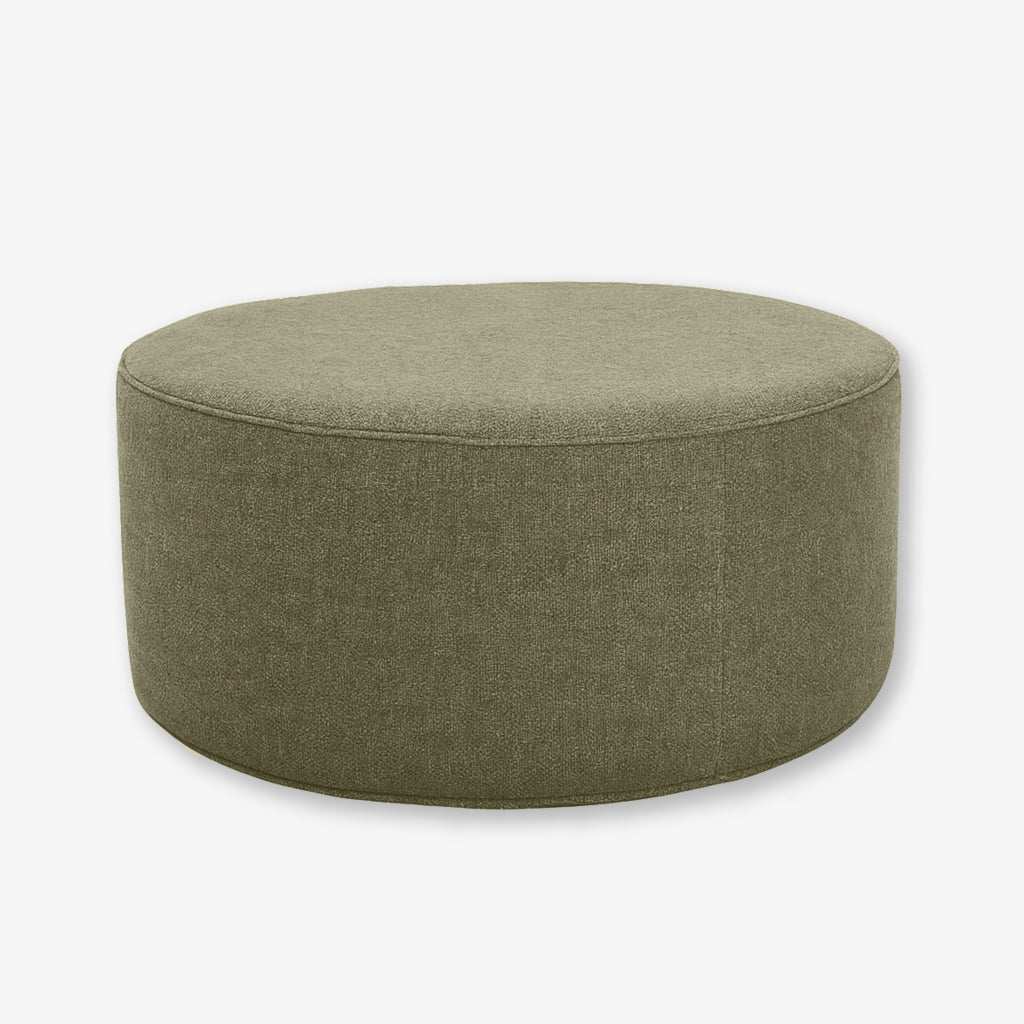 Round Verde Olive upholstered ottoman with soft fabric and customizable piping options