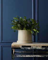 Robert Gordon Garden To Table stoneware planter with tray on rustic table against blue paneled wall