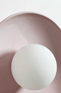 Robert Gordon Dish Wall Sconce in rose quartz ceramic with white globe light fixture