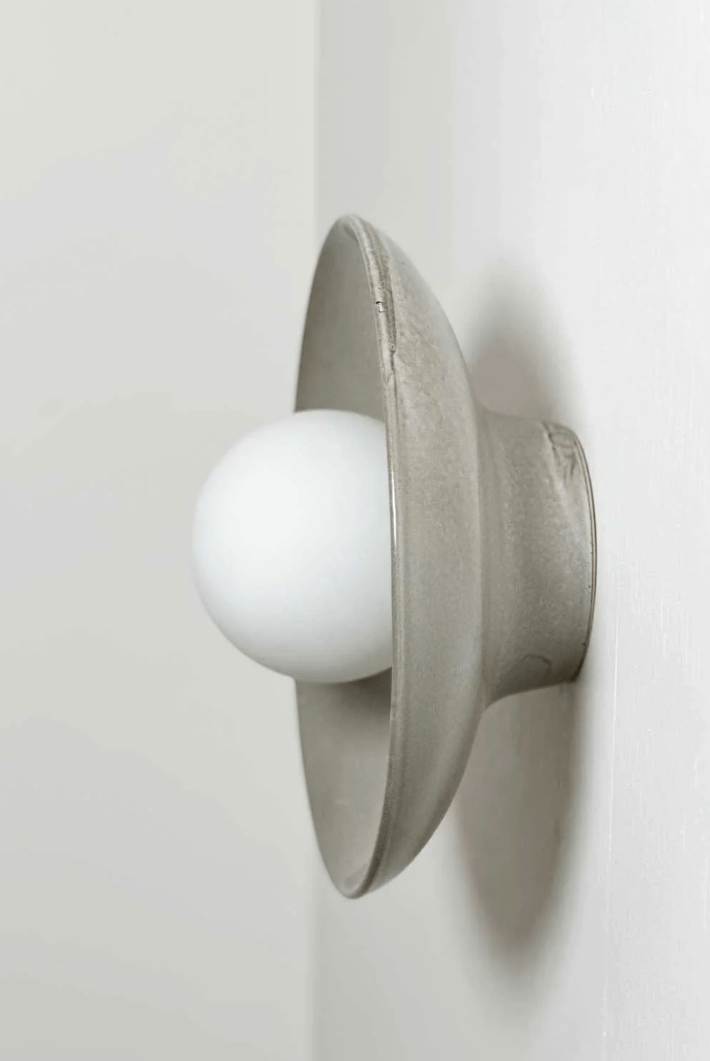 Robert Gordon Dish Wall Sconce ceramic light fixture with round white globe and handmade dish shade mounted on wall