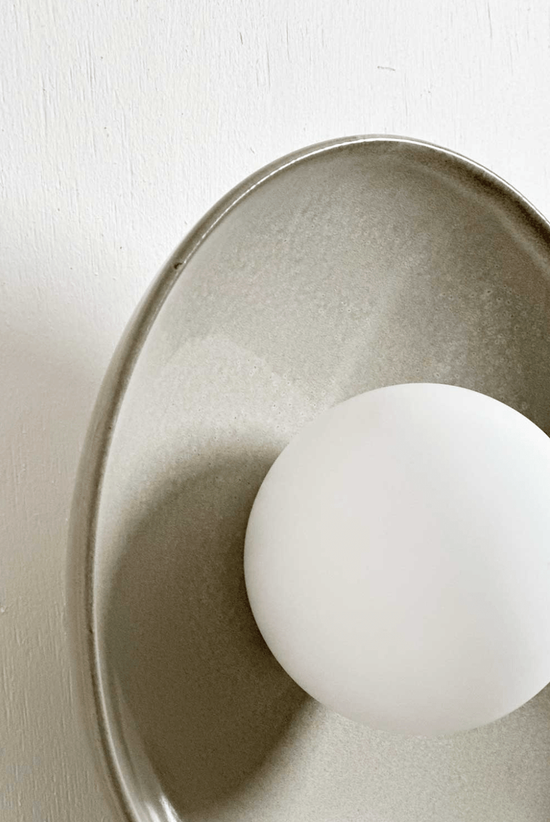 Robert Gordon Dish Wall Sconce ceramic light with hand-glazed finish and round frosted globe