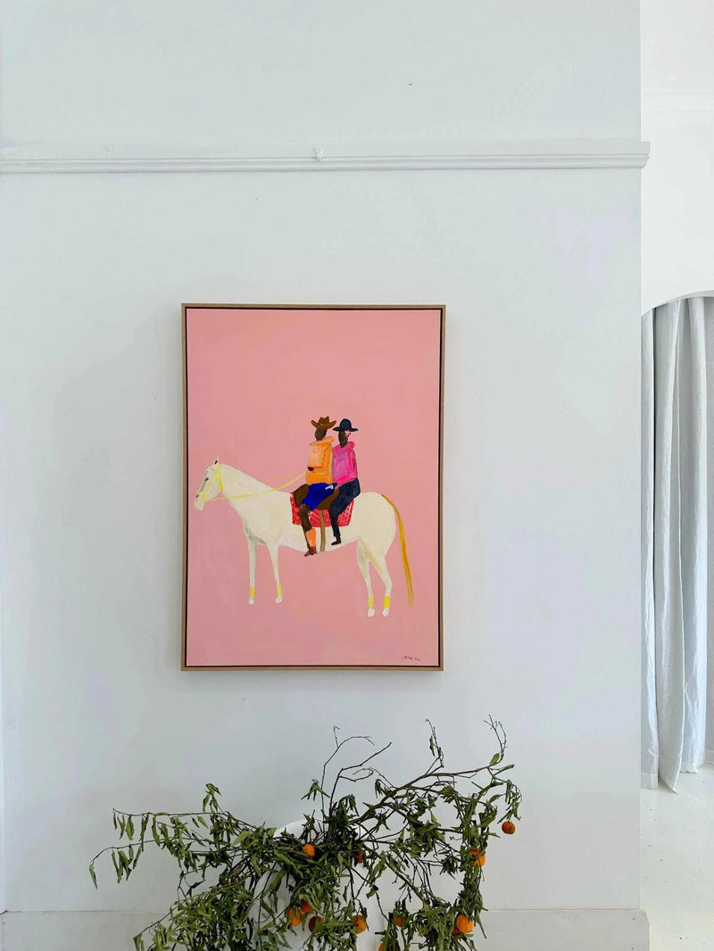 Oak framed Lottie Rae Smooth Operator fine art canvas print featuring two figures on a white horse with a pink background.