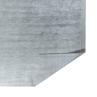 GlobeWest Bower Frame Seaside Blue rug folded corner showing handloom backing